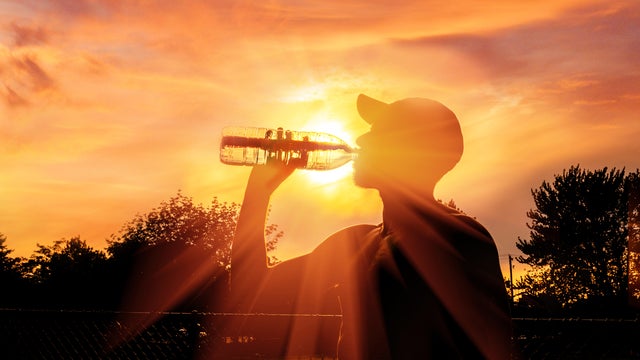 Man drinking water during heat wave 