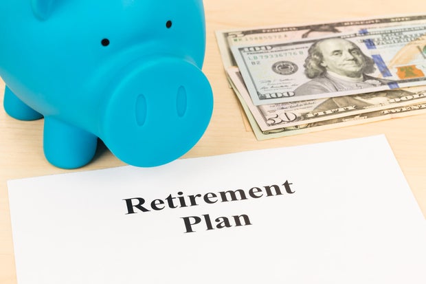 Retirement plan with banknote, piggy bank, and pen 