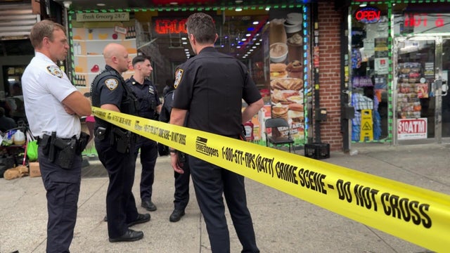 Crime scene tape and police outside a Brooklyn deli 