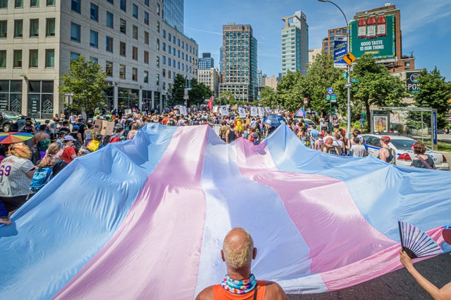 A giant Trans Flag seen at the march. Thousands of New 