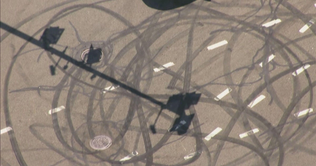 Photos show skid marks left from 100 cars street racing in Newton 