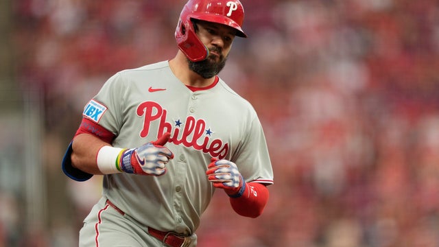 Philadelphia Phillies designated hitter Kyle Schwarber gives the thumbs-up as he rounds third base after hitting a two-run homer during the eighth inning of a baseball game against the Cincinnati Reds 