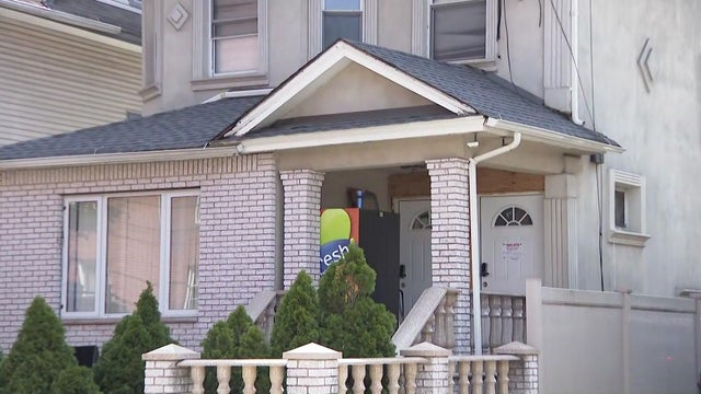 A Queens home with a vending machine on the front porch and a vacate order on the front door 