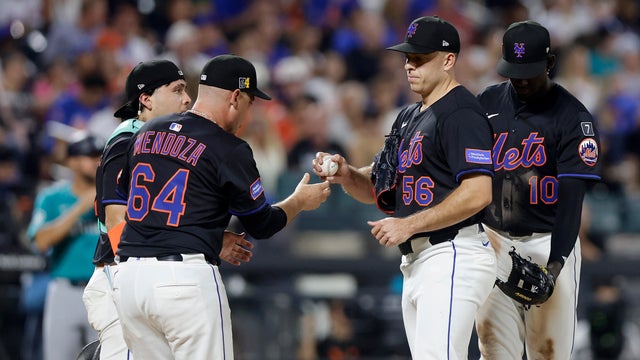 Ryan Helsley #56 of the New York Mets hands the ball to manager Carlos Mendoza #64 as he is removed from a game against the Seattle Mariners in the seventh inning at Citi Field on August 15, 2025 in New York City. 