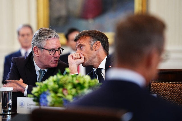 British Prime Minister Keir Starmer speaks with French President Emmanuel Macron  during a multilateral meeting in the East Room of the White House in Washington, D.C., on Monday, Aug. 18, 2025. 
