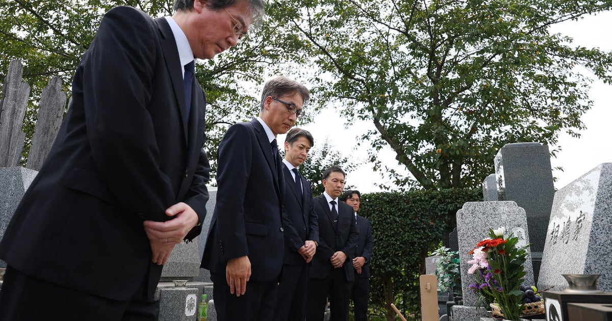 Police apologize at grave of Japanese businessman who was wrongfully arrested and died after lengthy detention