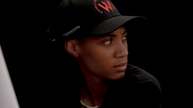 Mo'ne Davis watches a scrimmage from the dugout during the third day of tryouts for the Women's Professional Baseball League 