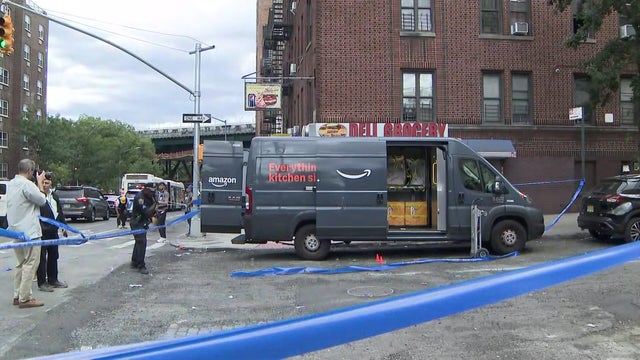 An Amazon truck behind crime scene tape at a Bronx intersection 