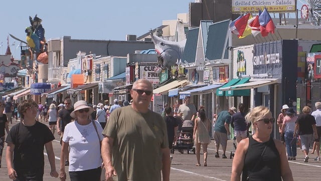 People walk on the boardwalk in Ocean City, New Jersey 