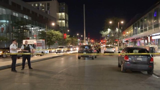 Police tape around a scene, police officers at the scene of the crash near Temple University that injured two people, one critically 