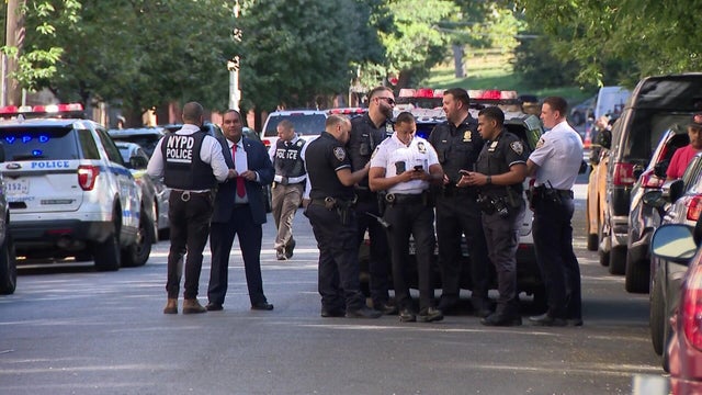 NYPD officers stand in the street 