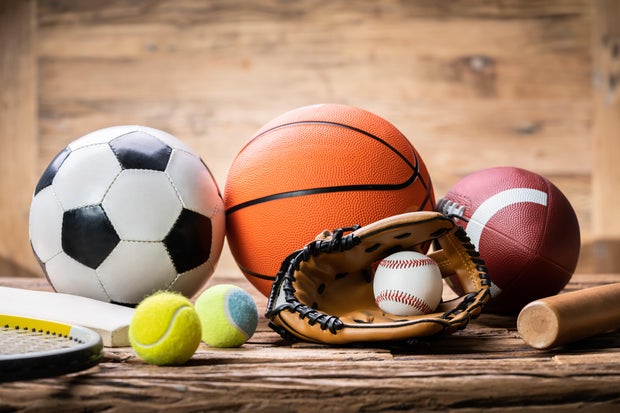 Variety Of Sport Accessories On Wooden Surface 