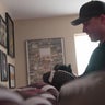 Dan Kolcun rubs mud on a football. 