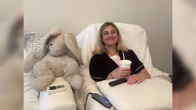 Dani Alderman lays in a hospital bed 