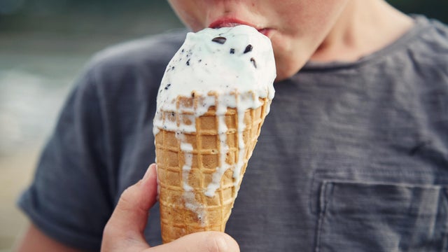 Child eating ice cream at the beach 