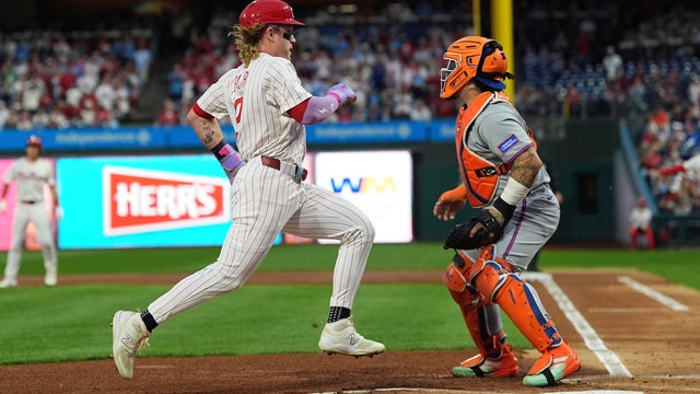 Philadelphia Phillies' Max Kepler scores past New York Mets catcher Francisco Alvarez off of a single hit by J.T. Realmuto during the first inning of a baseball game at Citizens Bank Park 