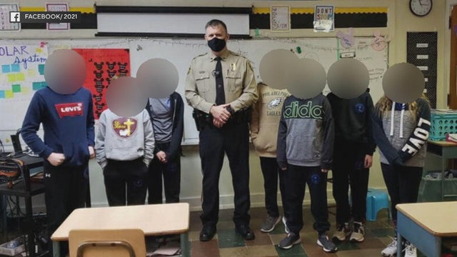 A photo posted by a Pennsylvania school showing Detective Mark Baker with students, whose faces are blurred, in a classroom 
