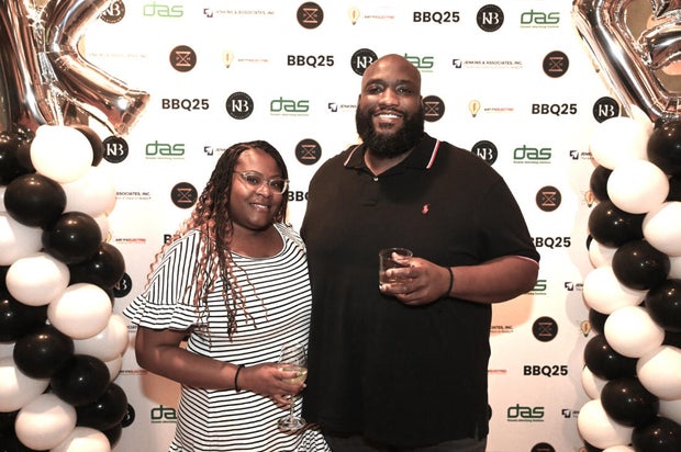 People pose for photos during the KB Foundation's BBQ Experience event