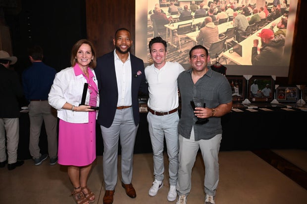 People pose for photos during the KB Foundation's BBQ Experience event
