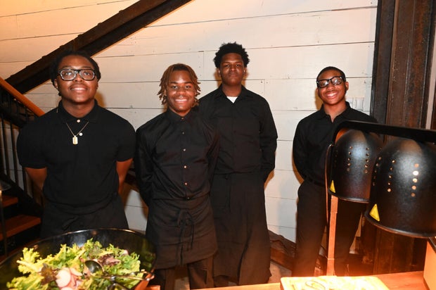 People pose for photos during the KB Foundation's BBQ Experience event