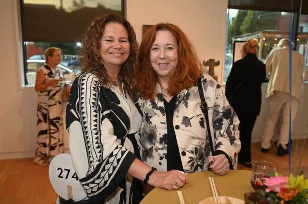 People pose for photos at Mud Ball 2025