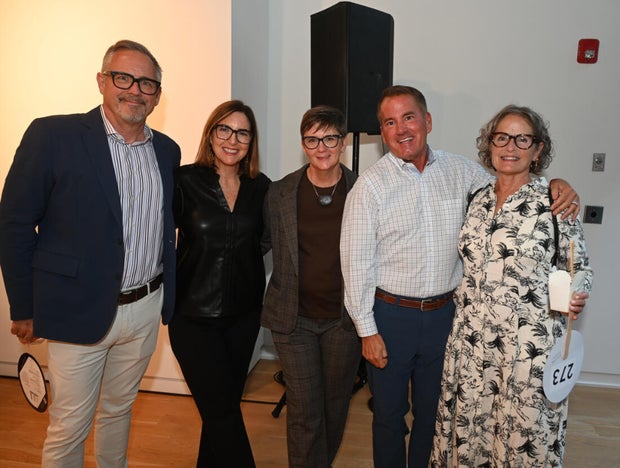 People pose for photos at Mud Ball 2025