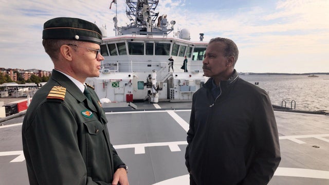 Coast Guard Cmdr. Mikko Simola and Bill Whitaker 