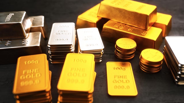Stacks of gold and silver ingots and coins 