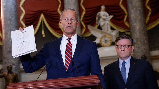 Senate Majority Leader John Thune of South Dakota holds a copy of a continuing resolution as he speaks alongside House Speaker Mike Johnson of Louisiana in Statuary Hall at the U.S. Capitol in Washington, D.C., on Oct. 3, 2025. 