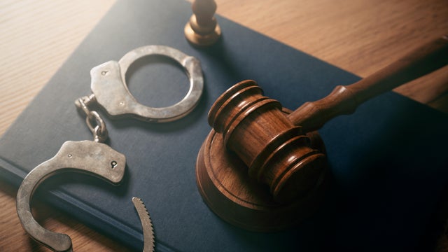 Handcuffs and wooden gavel. Crime concept. 