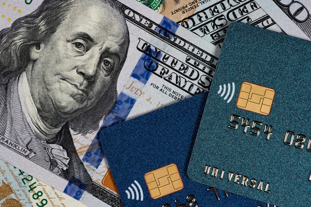Credit cards and dollars in cash close up 