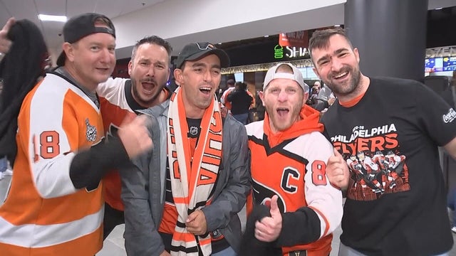 Flyers fans cheer for the team from the arena concourse 