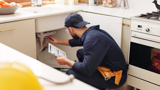 Plumber, house and handyman with clipboard, inspection and maintenance with expert. Employee, contractor and repair with checklist, service or quality control with industry, home renovation or skills 