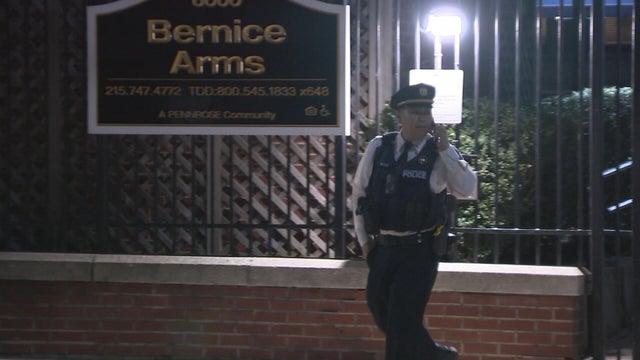 A police officer is seen outside the Bernice Arms apartment building in West Philadelphia 