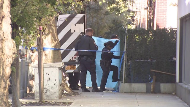 Police hold sheet to block view outside Brooklyn building 