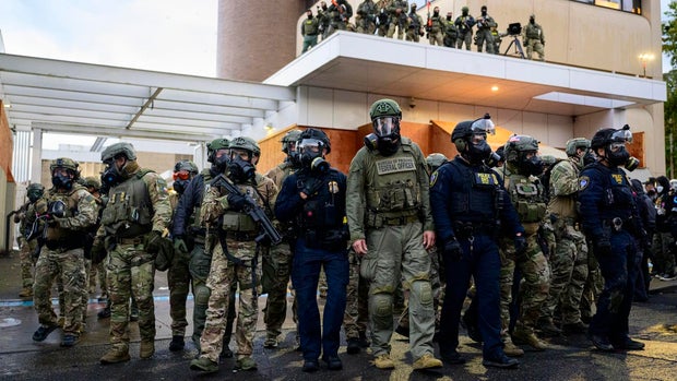 Federal agents at a Immigration and Customs Enforcement building in Portland, Oregon, on Oct. 12, 2025. 