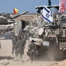 Israeli soldiers stand next to tanks near the Israel-Gaza border, in Israel 
