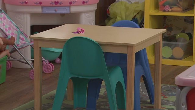 A small table in a preschool classroom sits empty 