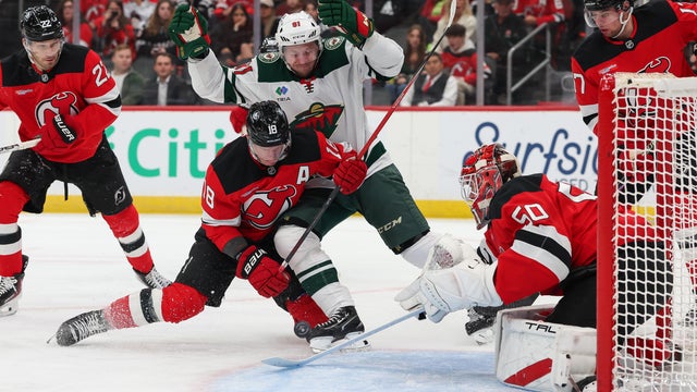 Ondrej Palat #18 of the New Jersey Devils and Vladimir Tarasenko #91 of the Minnesota Wild battle for the puck in front of Nico Daws #50 of the New Jersey Devils during the first period of the NHL game at Prudential Center on October 22, 2025 in Newark, New Jersey. 