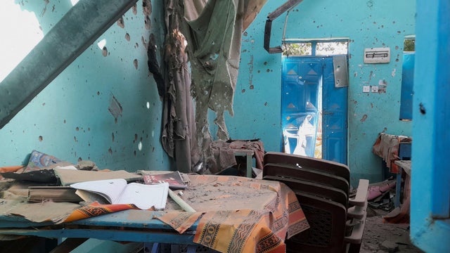 A desk bearing signs of shelling in a school where displaced people are sheltering, in El Fasher