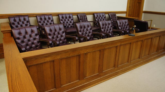 American jury box, wood trim and white walls in background