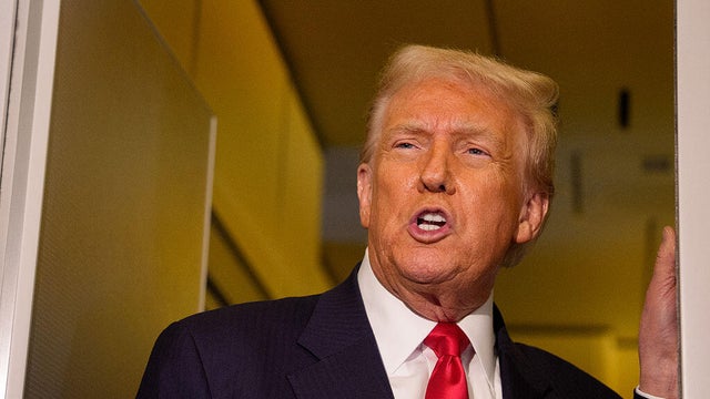 President Trump speaks to members of the media aboard Air Force One on Oct. 30, 2025.