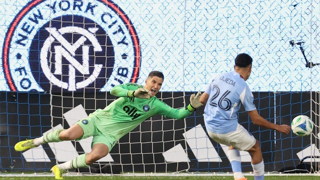 Charlotte FC goalkeeper Kristijan Kahlina (1) dives to save a shot by New York City forward Agustín Ojeda (26) during a shootout during Game 2 in the first round of MLS soccer's Eastern Conference playoffs Saturday, Nov. 1, 2025, in New York. 