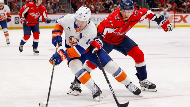 Martin Fehérváry #42 of the Washington Capitals makes a defensive pay against Bo Horvat #14 of the New York Islanders during a game at Capital One Arena on October 31, 2025 in Washington, D.C.