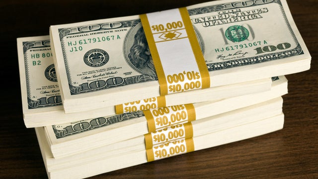 $50,000 in US $100 Bills on a Walnut Desk 