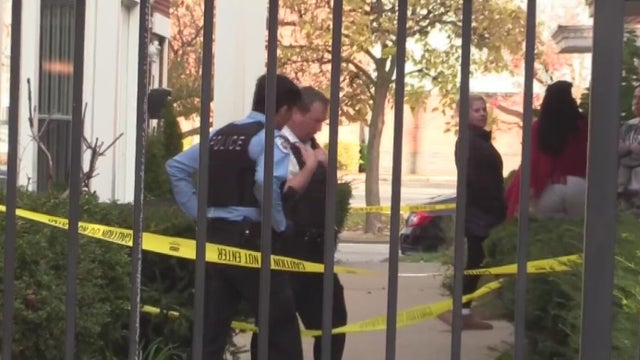 a close-up view of a police vehicle with blue lights patrolling near a public park with the windows and doors closed 