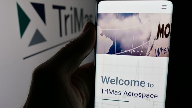 In this photo illustration, a person is holding a smartphone 