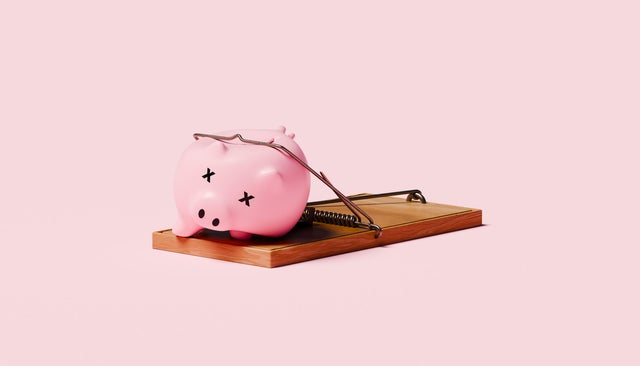Piggy Bank with X Eyes Trapped in Mousetrap Symbolizing Financial Loss and Economic Risk