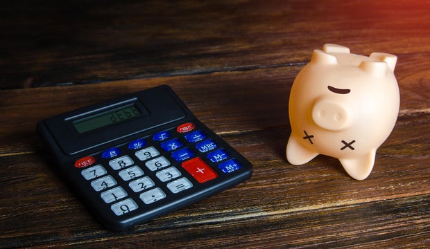 Debts and depleted savings. Dead empty piggy bank. Bankruptcy and business closure due economic crisis. Refinancing and restructuring of debts, reduction of losses. Debt cancellation