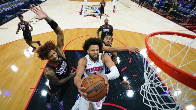 Detroit Pistons' Cade Cunningham, center, goes up for a shot against Philadelphia 76ers' Kelly Oubre Jr. in Philadelphia 